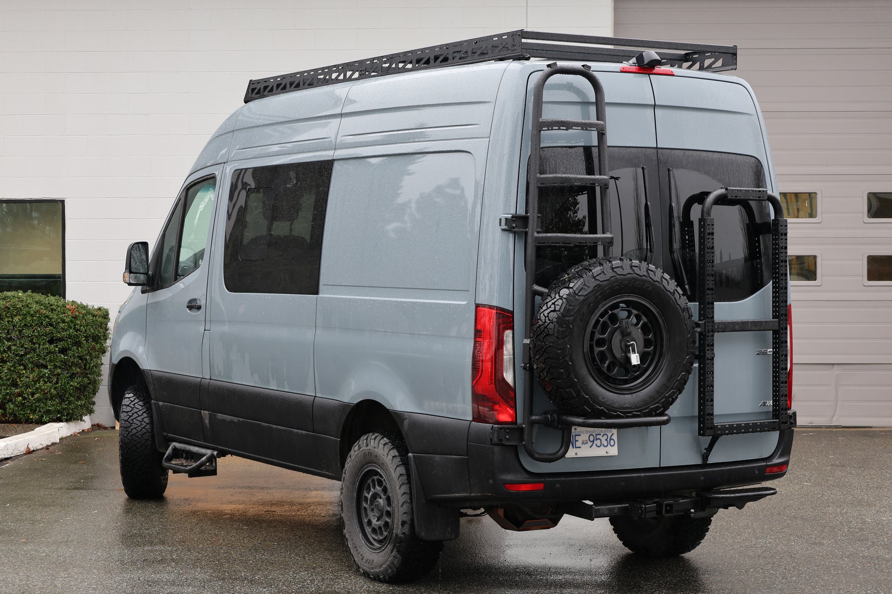 Curved extruded anti-slip steps on the Tec Vanlife Sprinter rear-door ladder