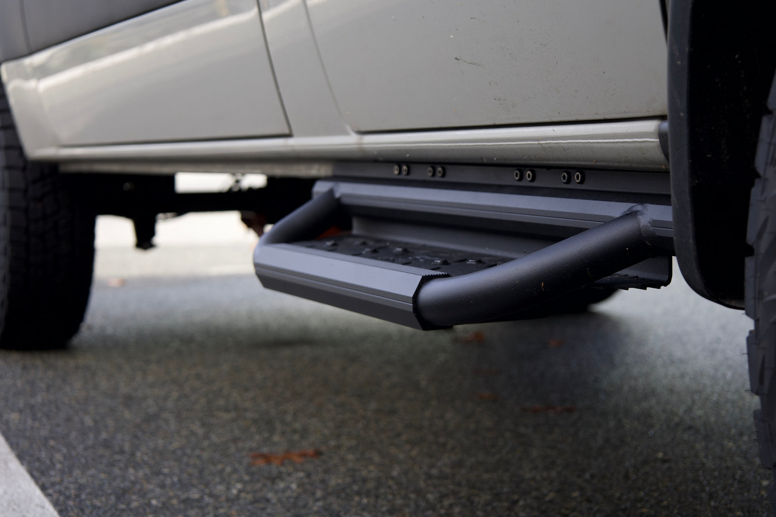 Hexagon running boards installed along a Sprinter van body